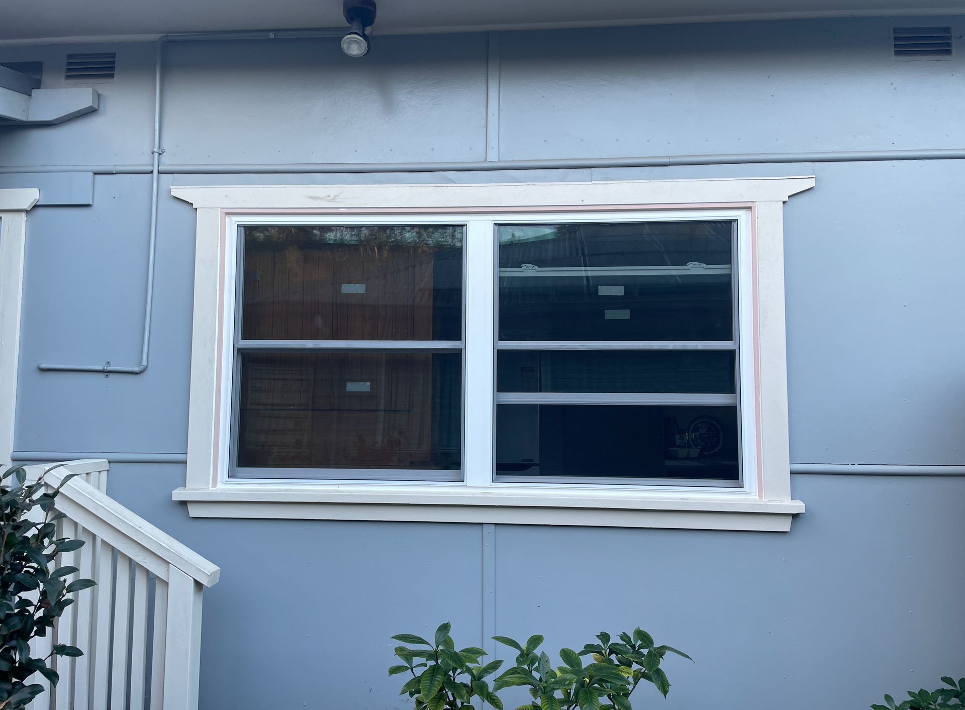blue weatherboard with white double glazed window