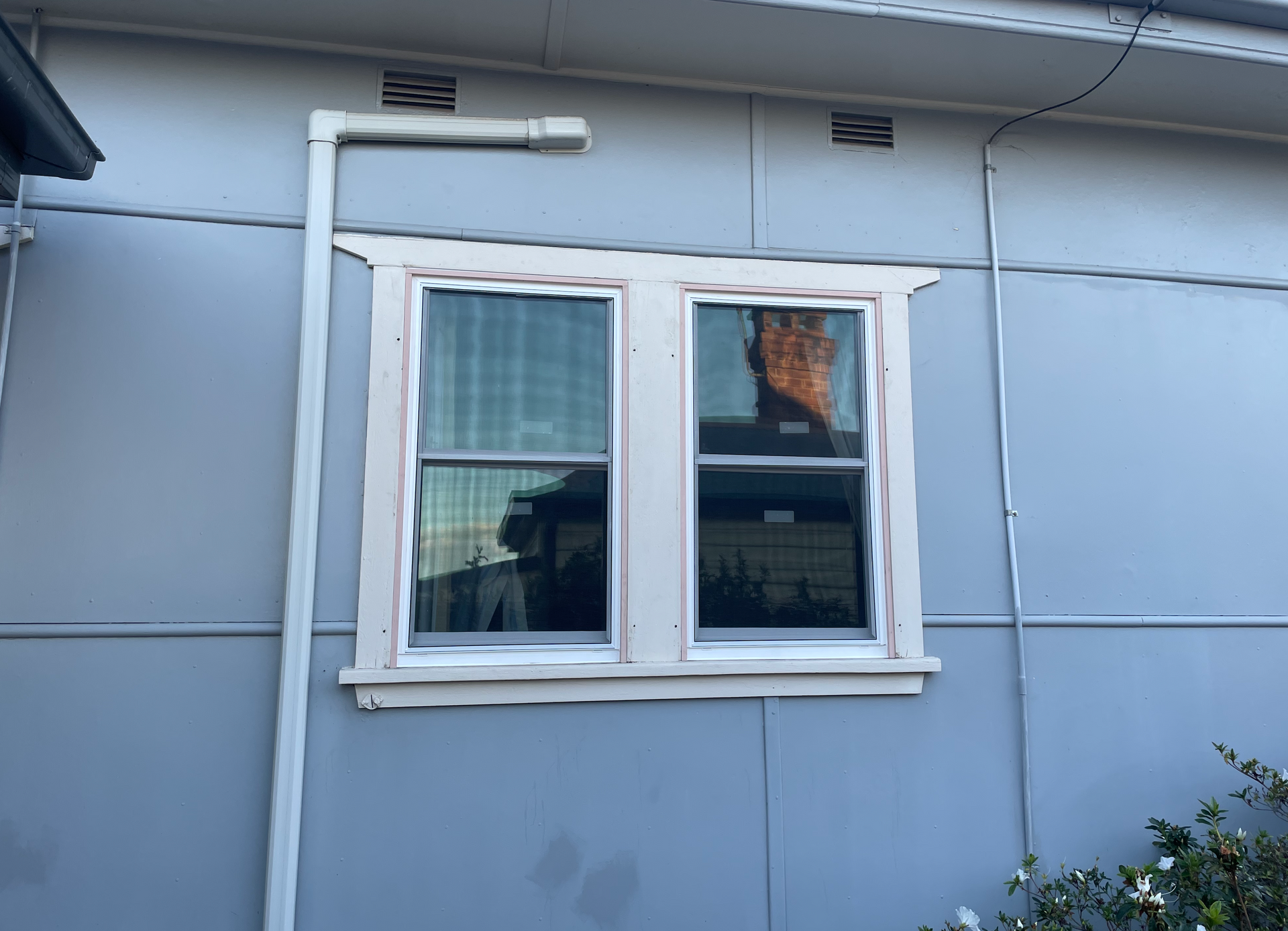 blue weatherboard with white double glazed window