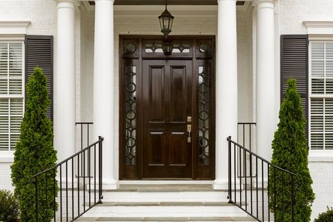 Door Installation — Dark Front Door With White Columns in Pace, FL