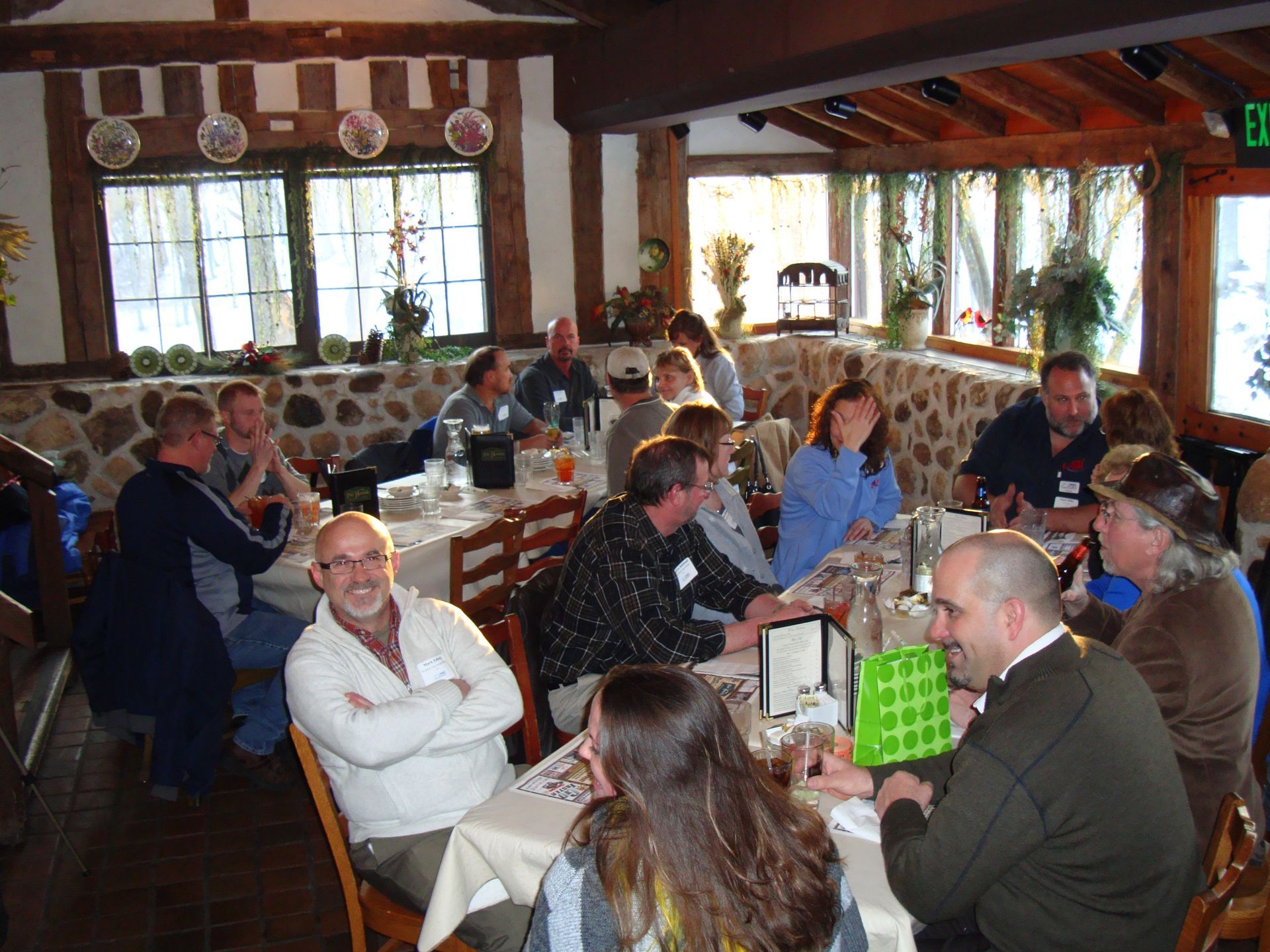 A group of people are sitting at tables in a restaurant