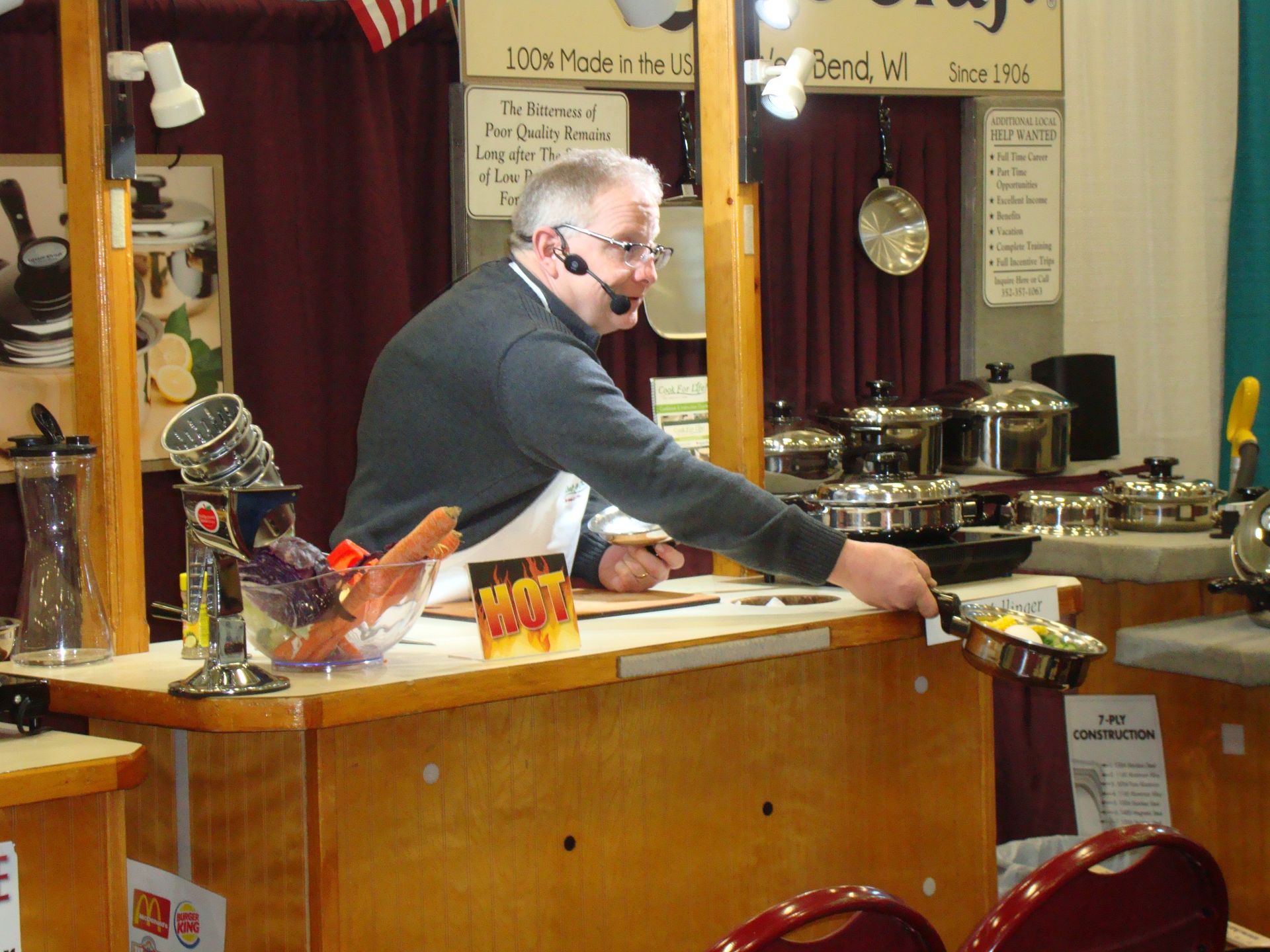 A man wearing a headset is cooking in a kitchen