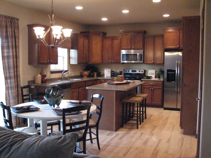 A kitchen with stainless steel appliances and wooden cabinets