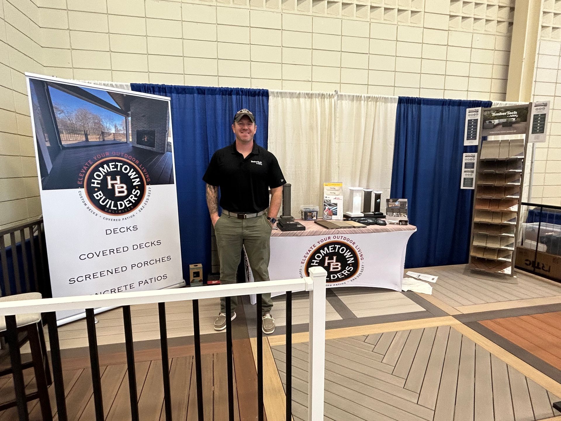 A man is standing in front of a table in a room.