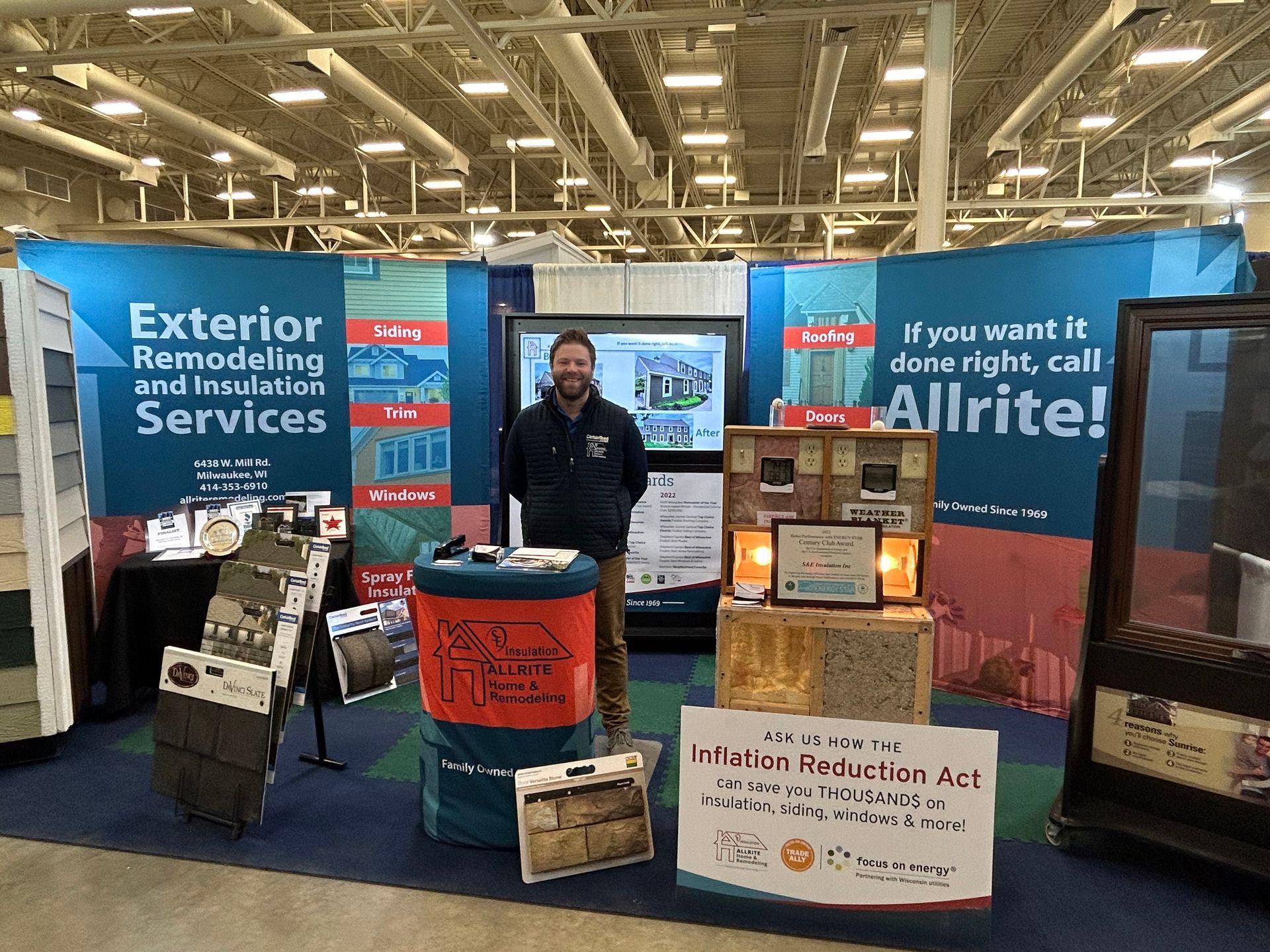A man is standing in front of a sign that says exterior remodeling and insulation services.