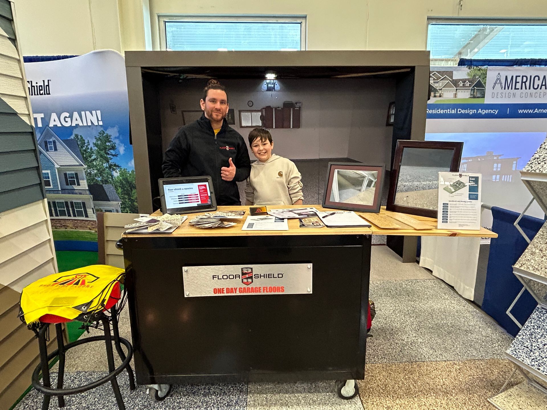A man and a woman are standing in front of a table in a store.