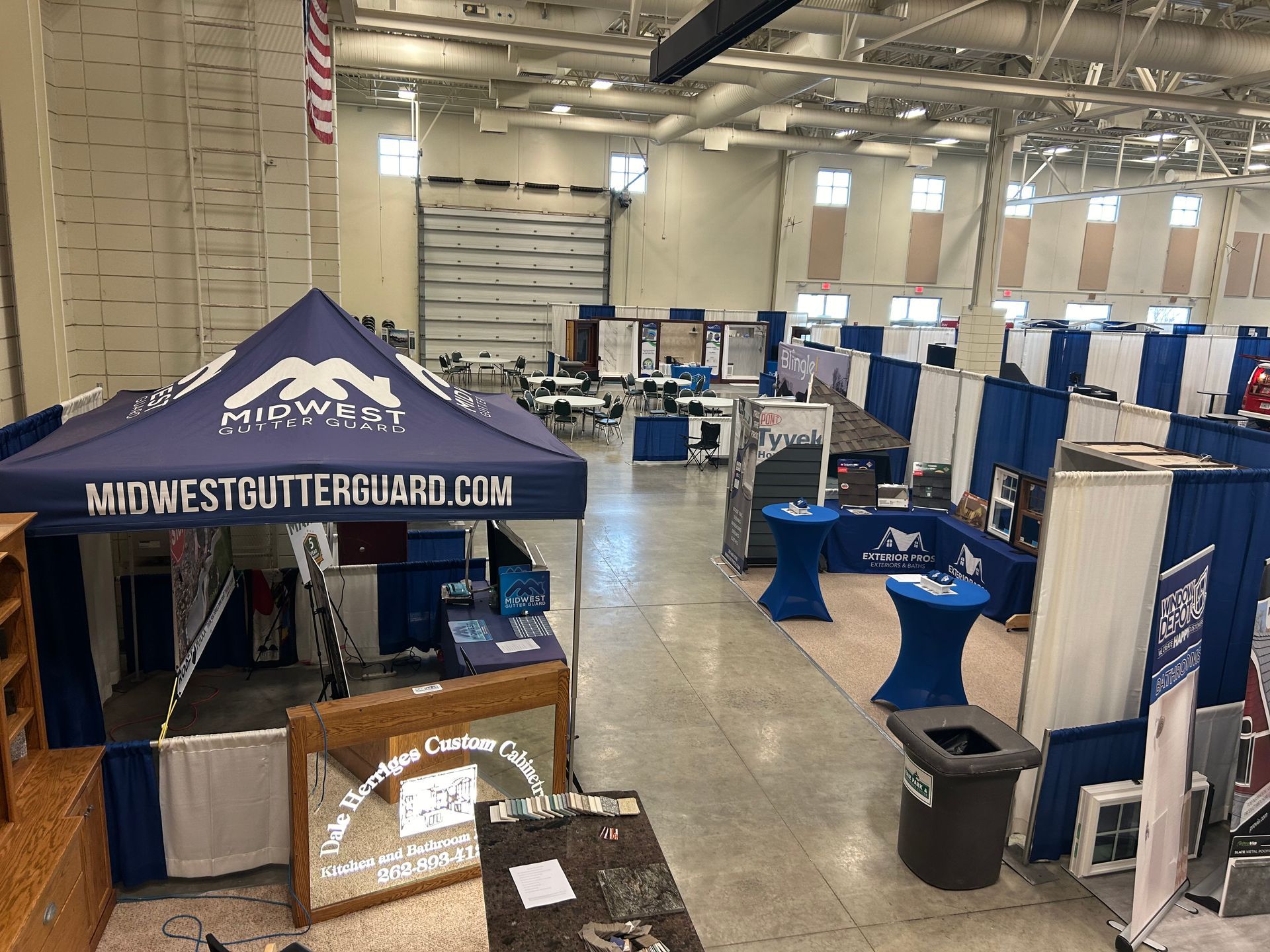 A large room with a blue tent in the middle of it.