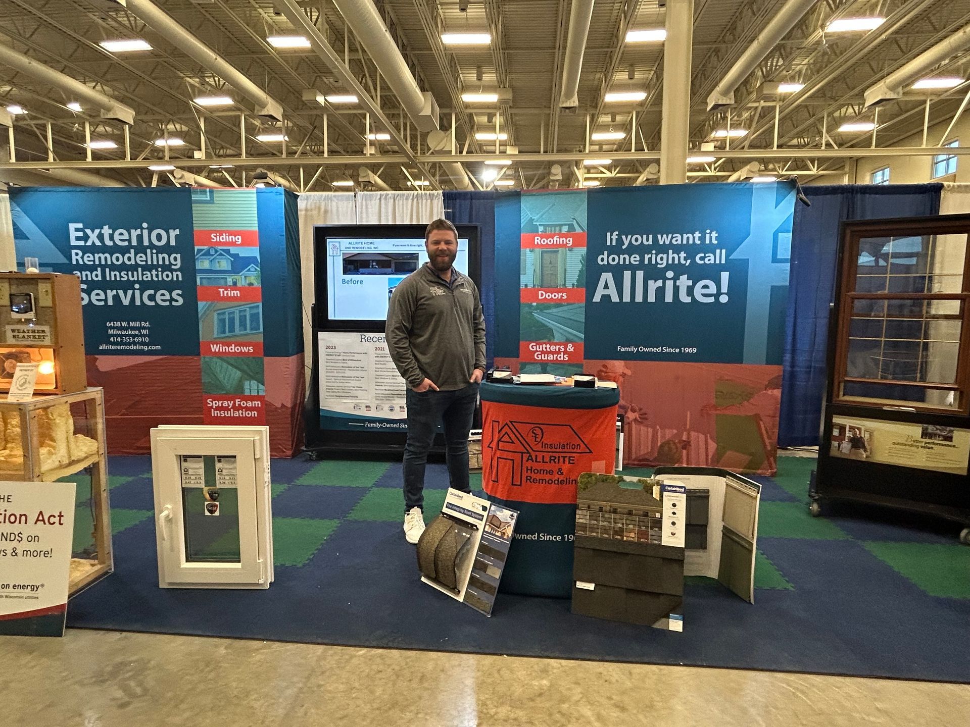 A man is standing in front of a sign that says allrite