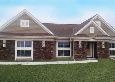 A large house with a lot of windows is sitting on top of a lush green lawn.