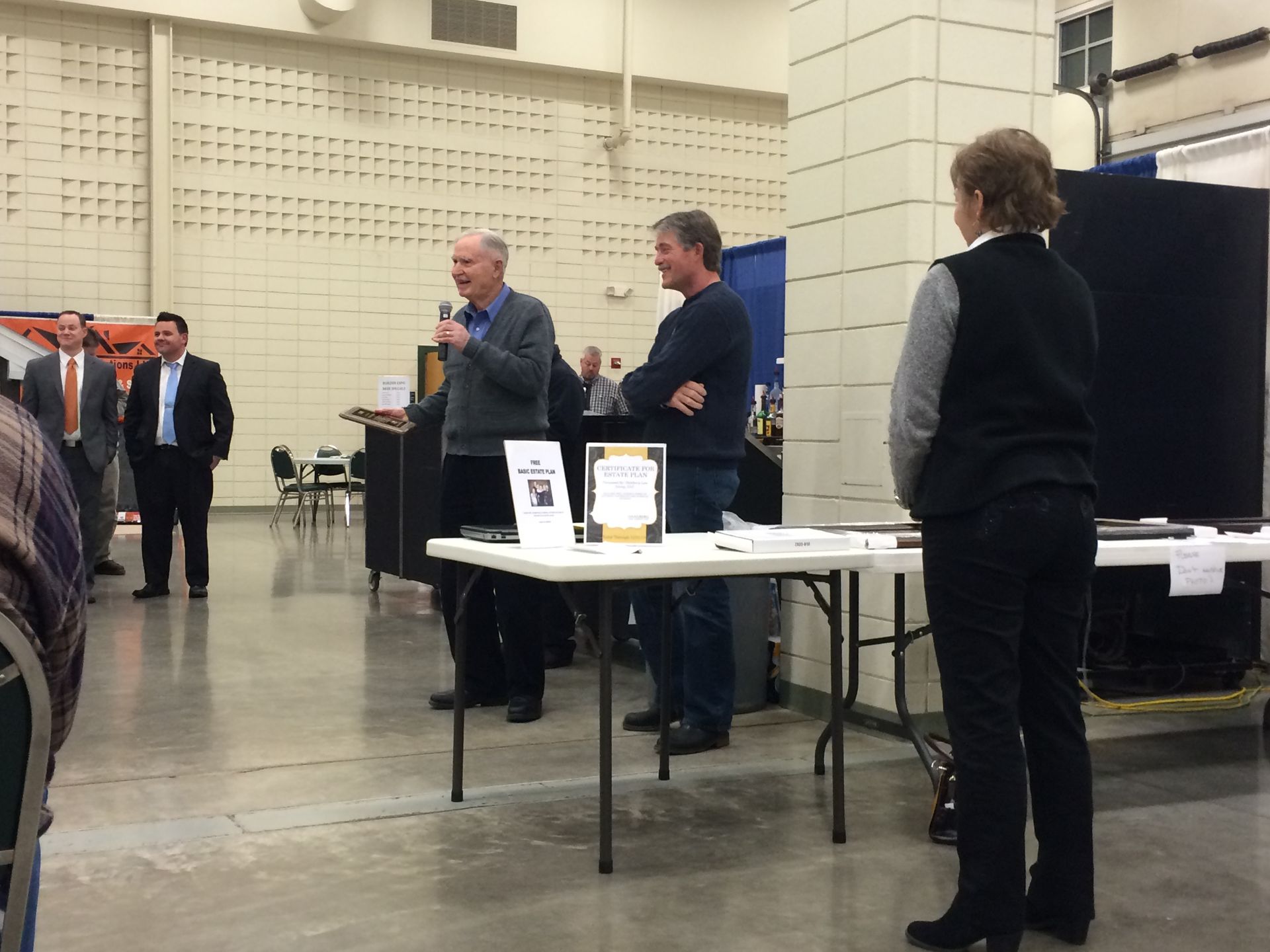 A group of people standing around a table in a room