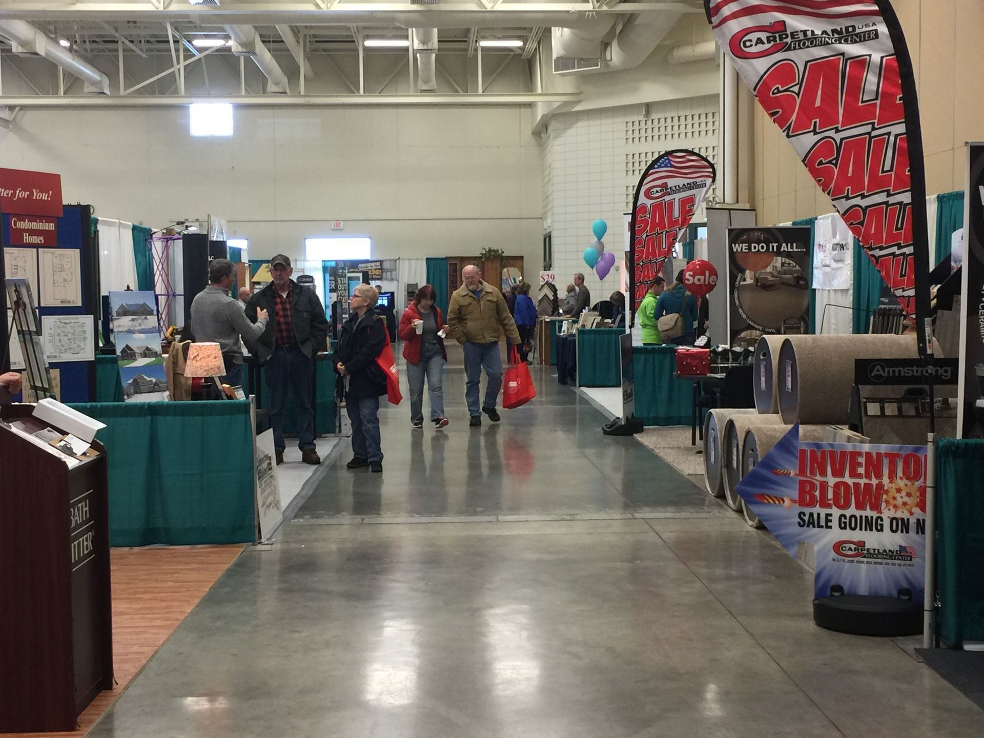 A group of people are walking down a hallway at a convention.