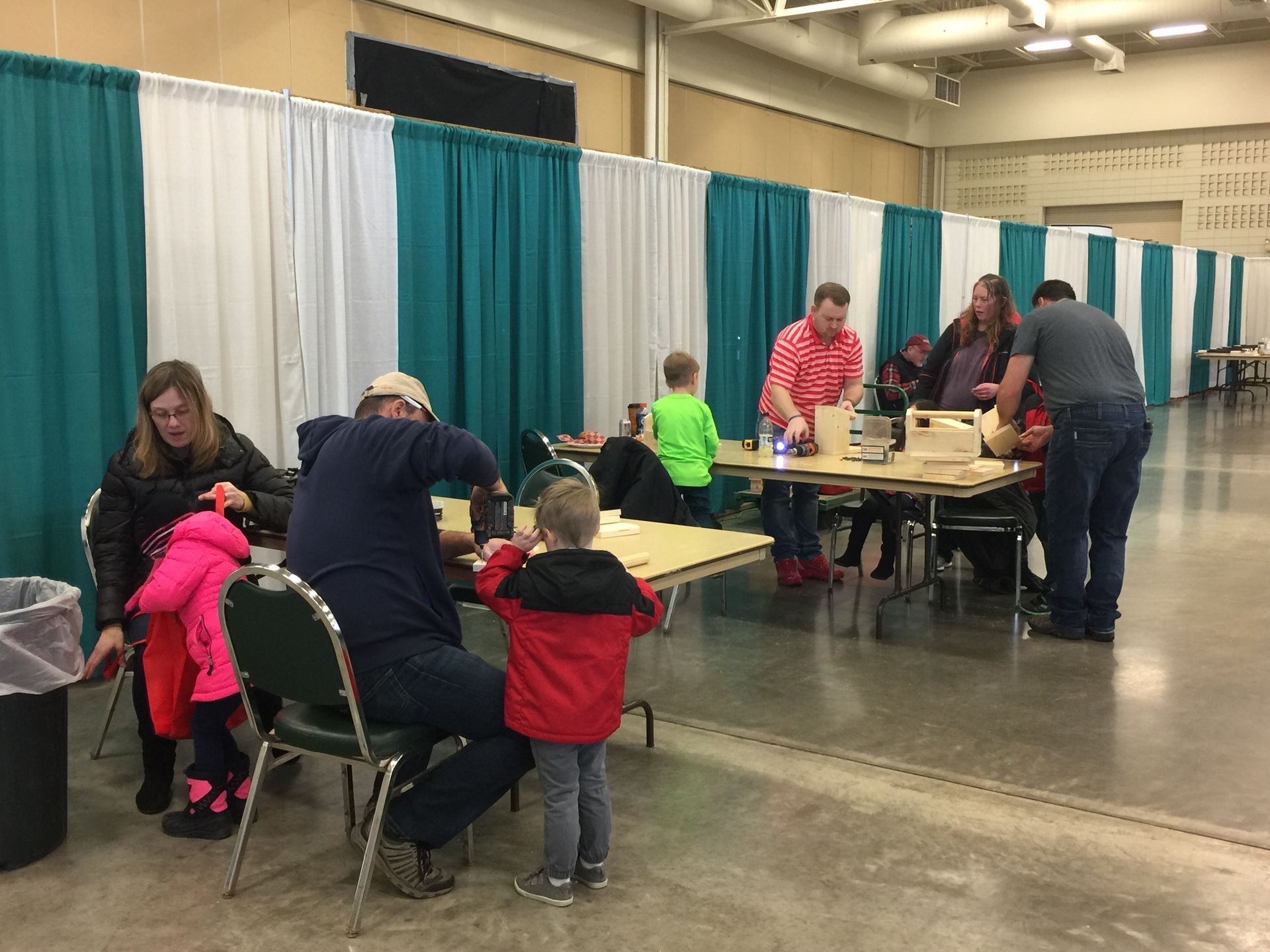 A group of people are sitting at tables in a room.