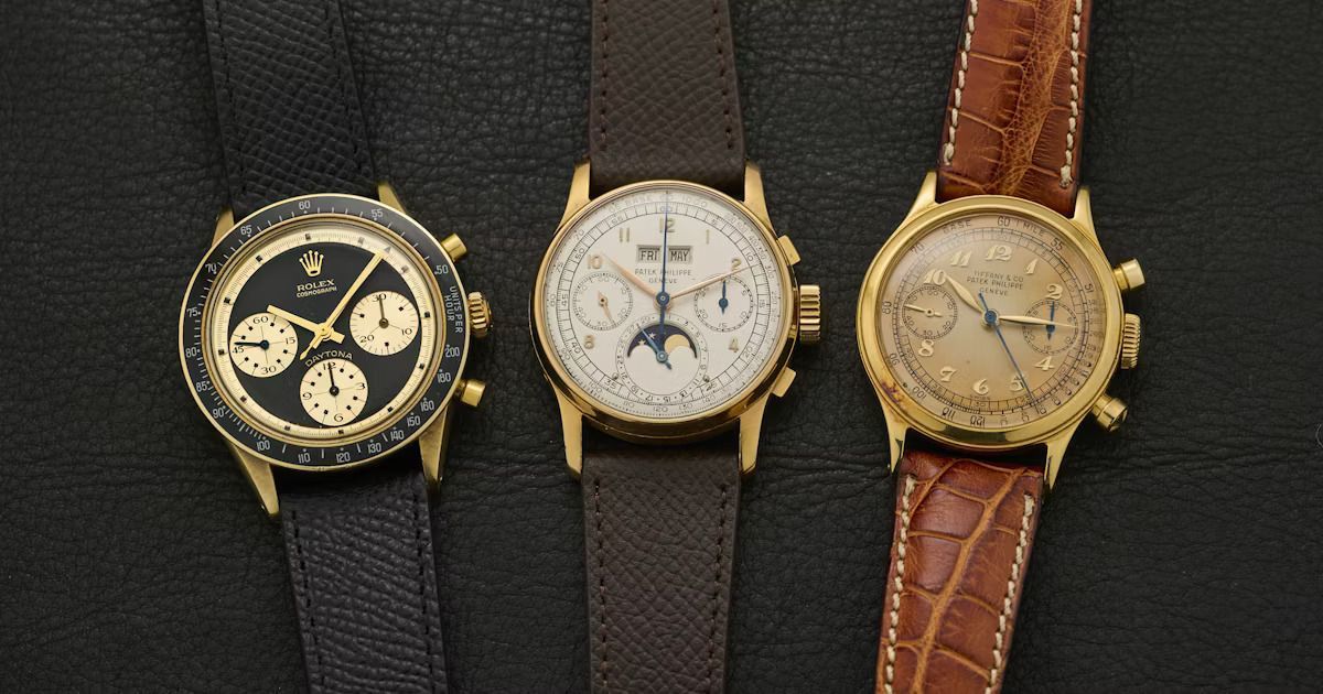 Three gold-toned vintage wristwatches with various dark and light colored leather watchbands, set on a dark background.