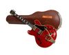 Red electric guitar with case.