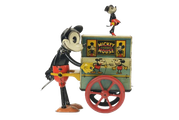 Vintage Mickey Mouse toy with a cart and dancing figure. Red, black, yellow, and turquoise colors.