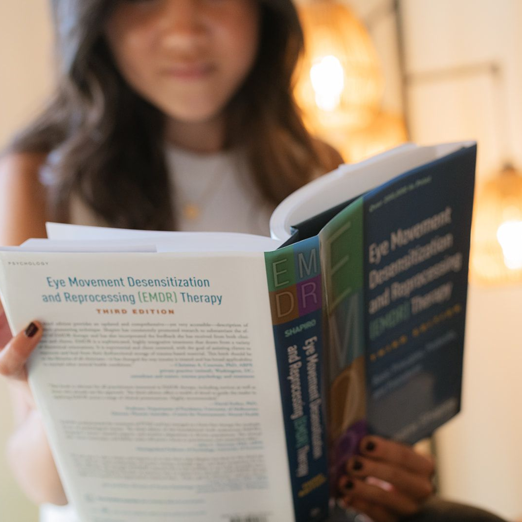 Rachel Chang, LMSW, therapist at Houston Healing Collective in Houston, TX reading a book