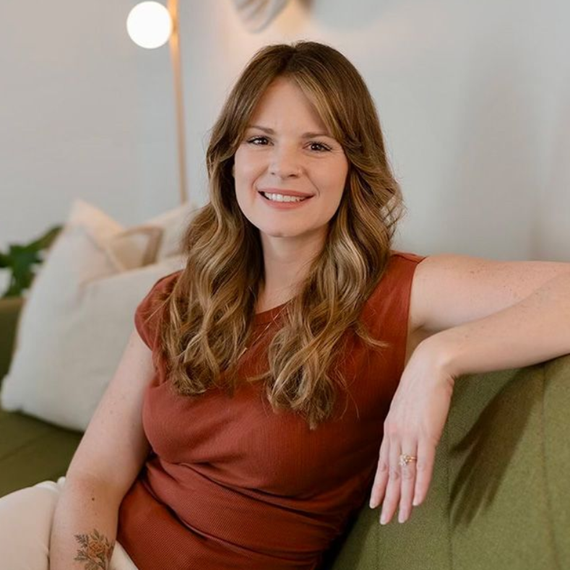 Jennifer Lancaster sitting on a couch.