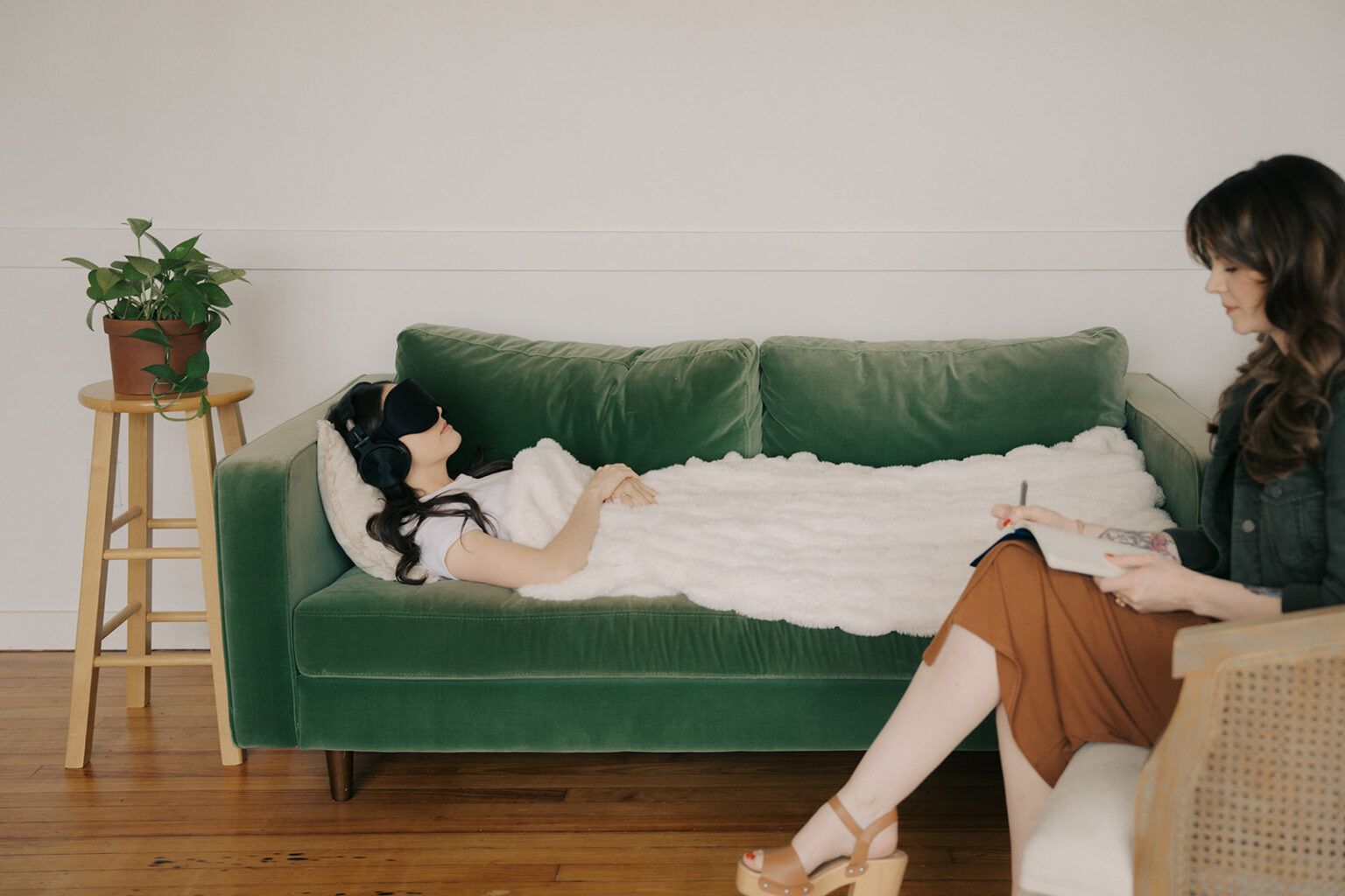 Client lying on a couch with eye mask during a ketamine-assisted psychotherapy session in Houston