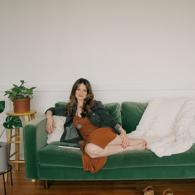 Jennifer Lancaster sitting on a couch.