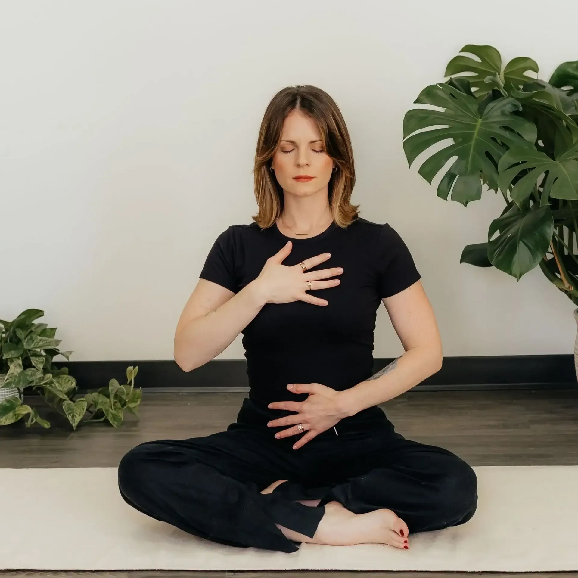 Woman practicing yoga and meditation at a mental health retreat.