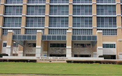 The brick exterior of the Winfred L. Wiser Hospital for Women and Infants, with its glass windows and lawn.