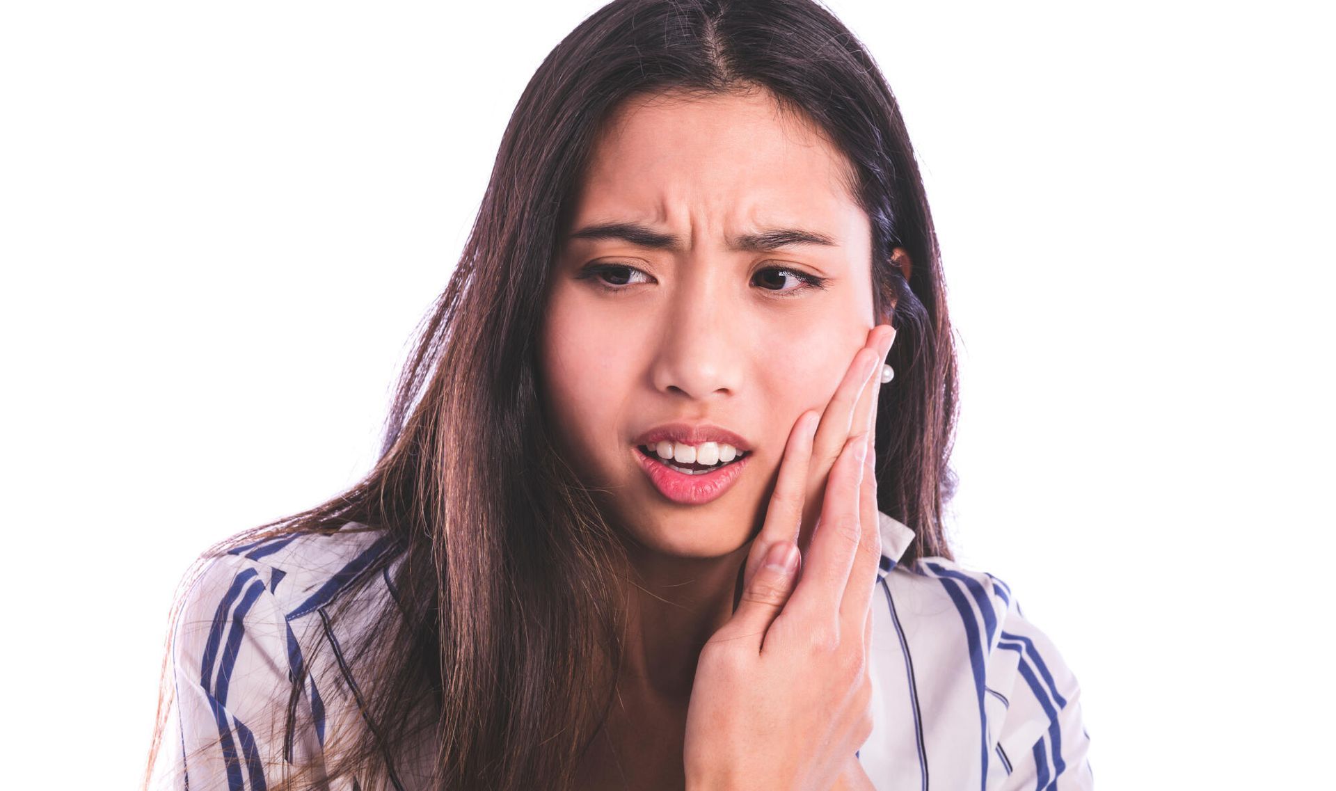 A woman is holding her face in pain because of a toothache.