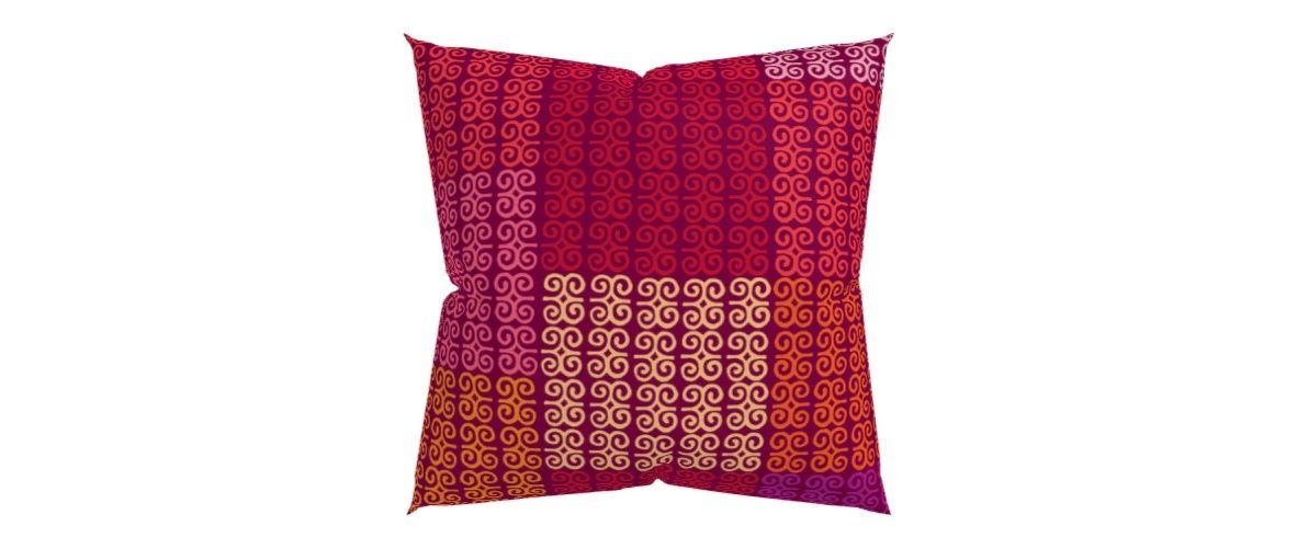 a red and purple pillow with a pattern on it