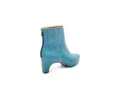 a pair of blue ankle boots on a white background .