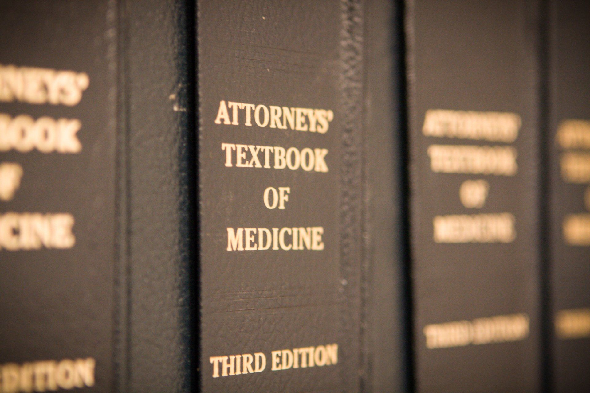A row of books titled attorney 's textbook of medicine