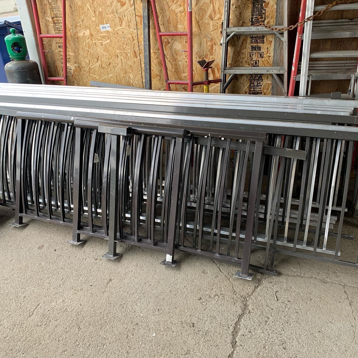 A bunch of metal bars are stacked on top of each other on the ground.