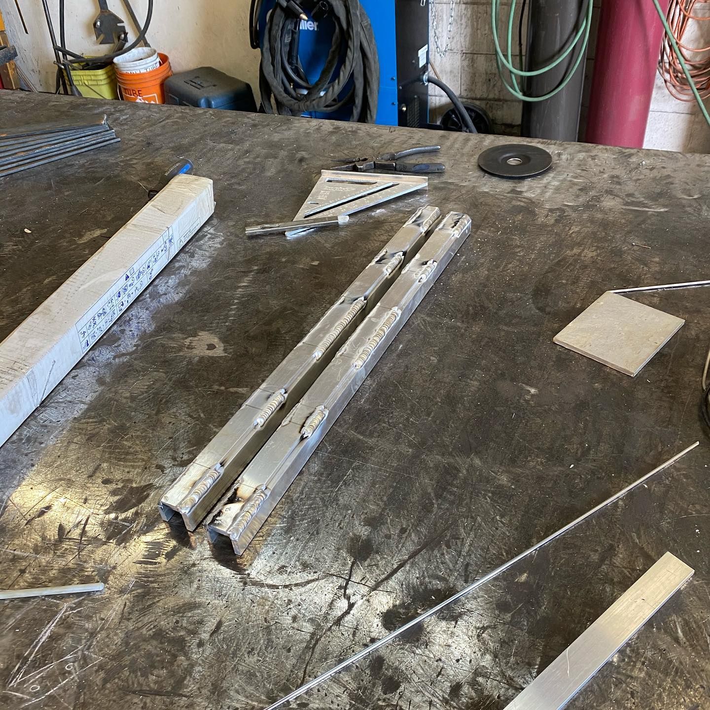 A table with a bunch of metal pieces on it