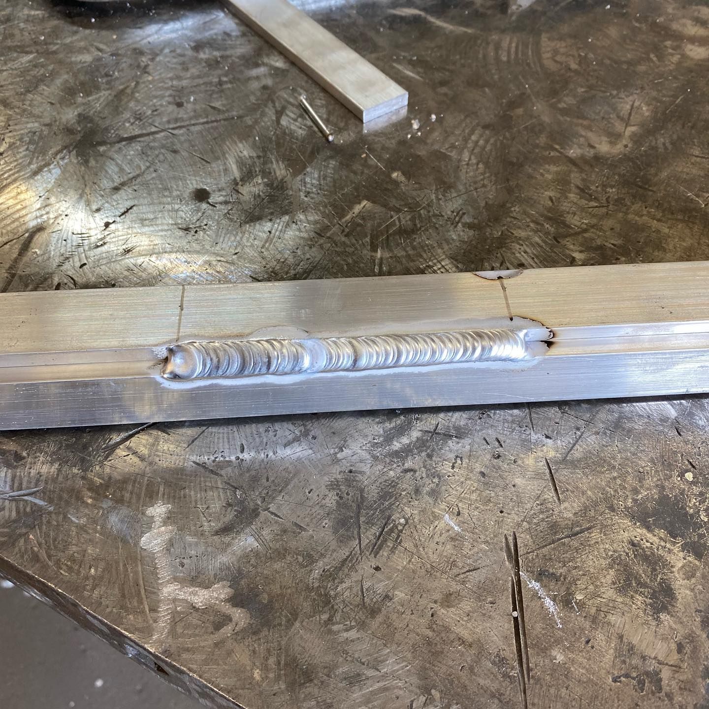 A piece of metal with a hole in it is sitting on a table.