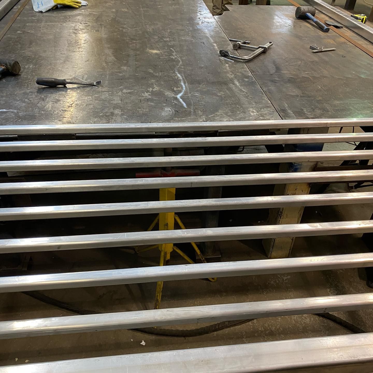 A bunch of metal bars are sitting on top of a table.