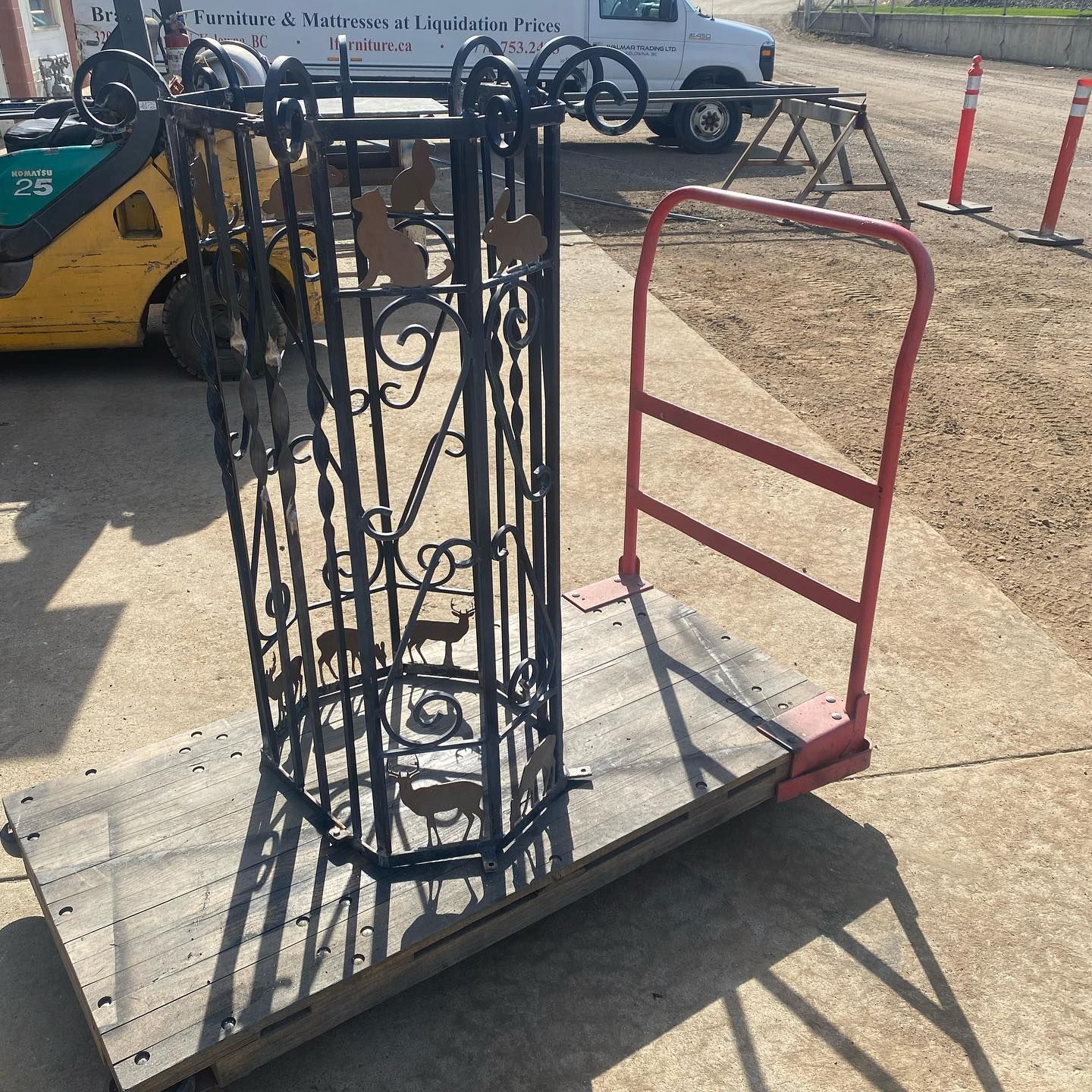 A cart with a wrought iron gate on it