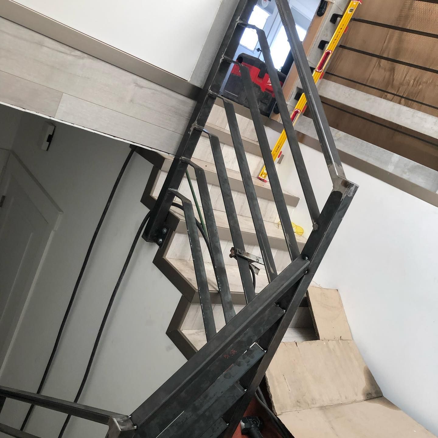 A staircase with a metal railing and wooden steps