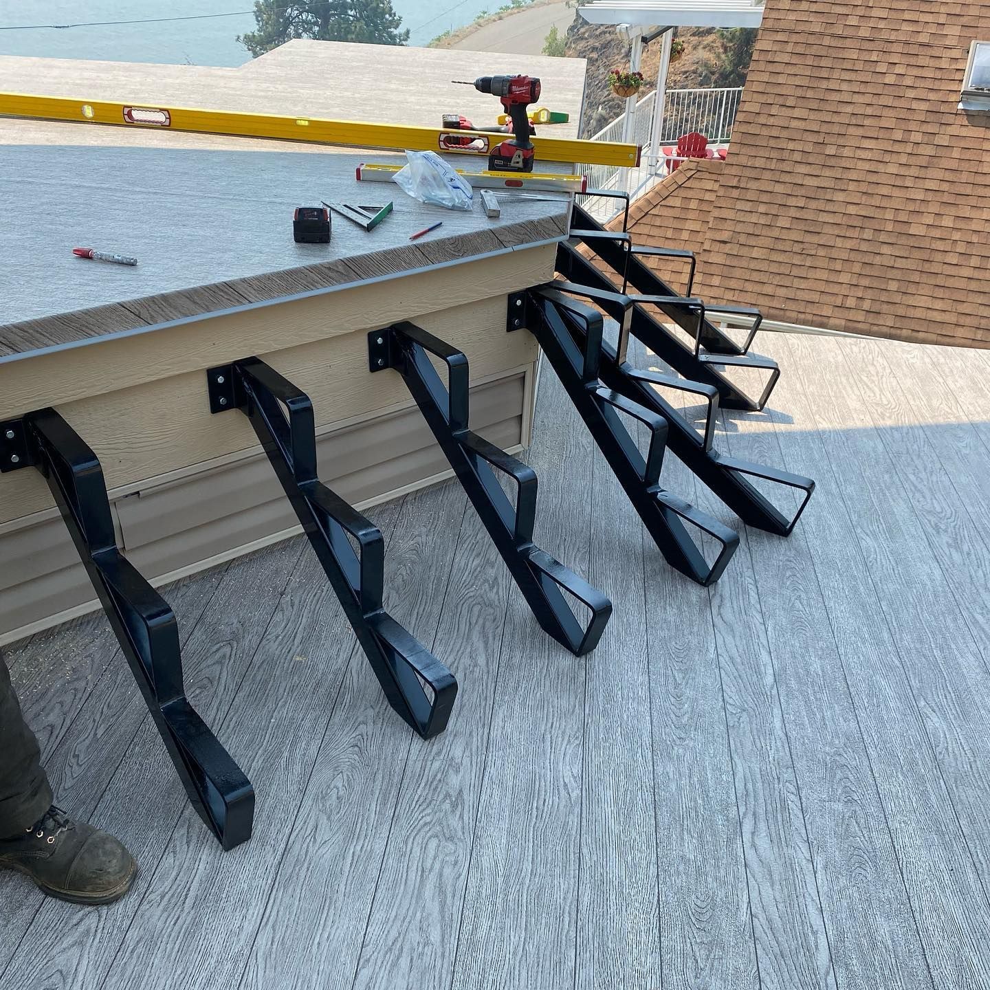 A person is working on a set of stairs on a roof.