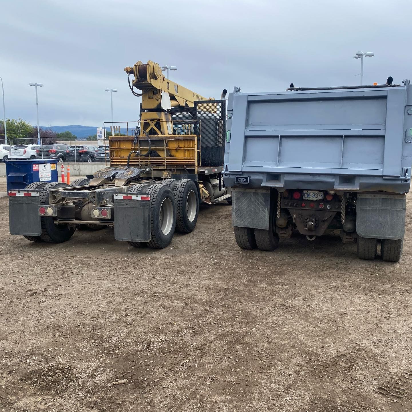 A dump truck with a crane attached to it