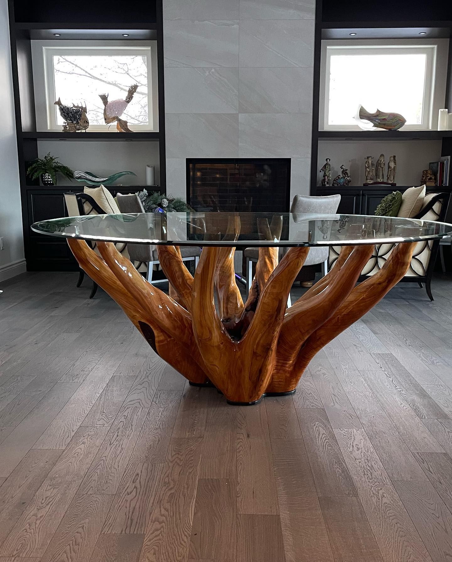 A glass table with a wooden base in a living room