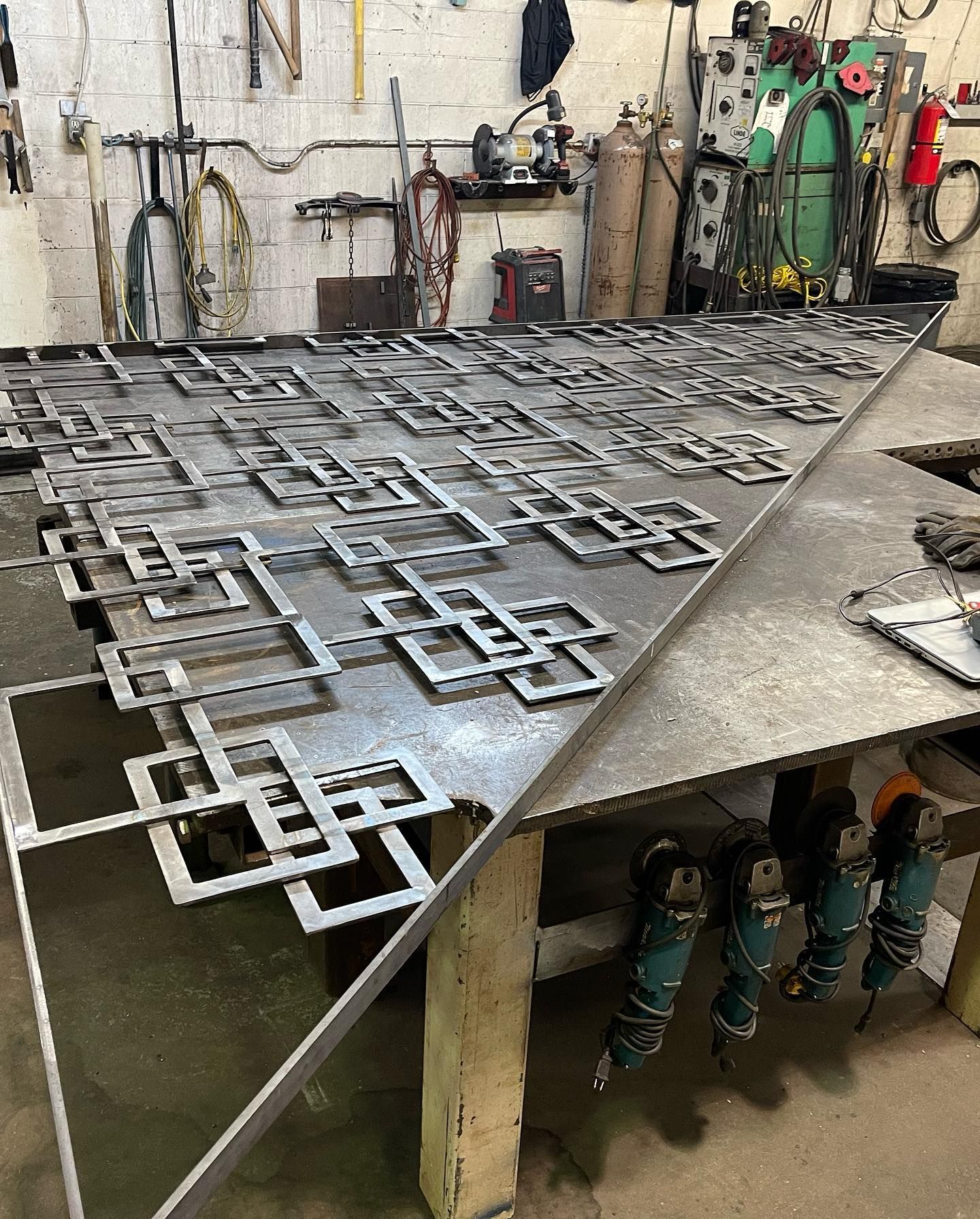 A large piece of metal is sitting on top of a table in a workshop.