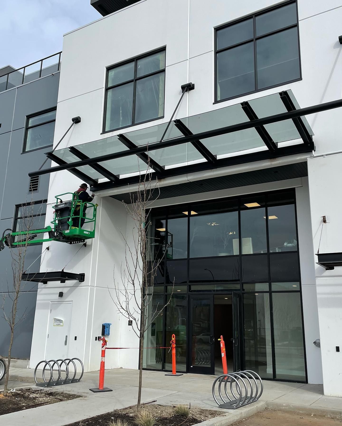 A white building with a glass canopy over the entrance
