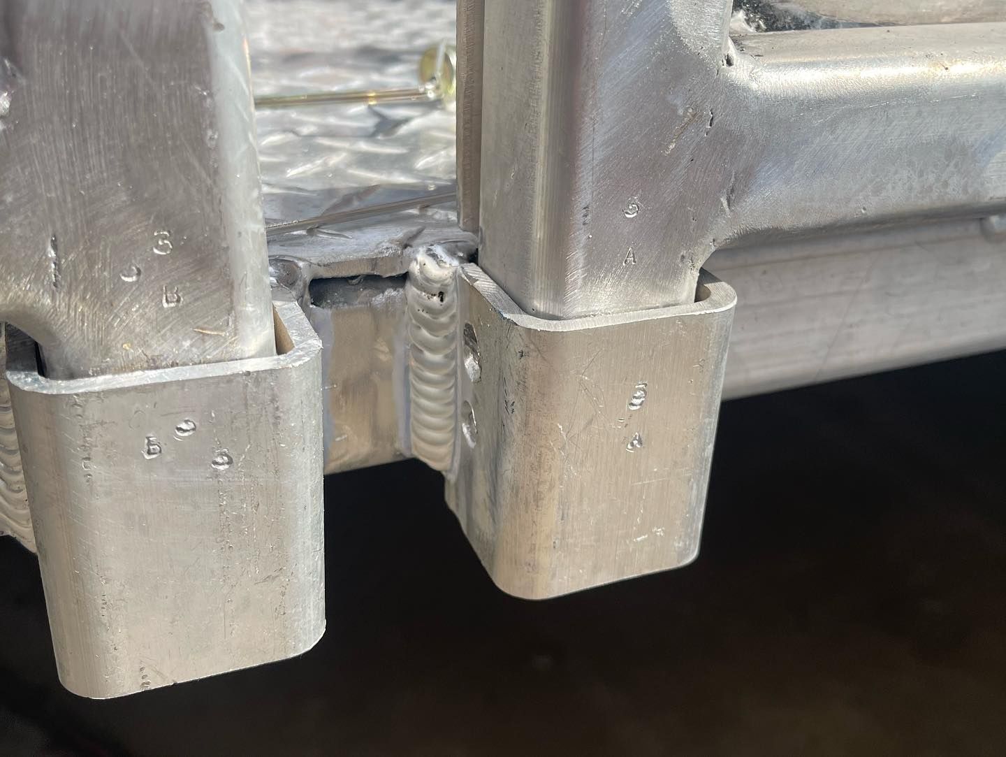 A close up of a metal object with a screw in it.