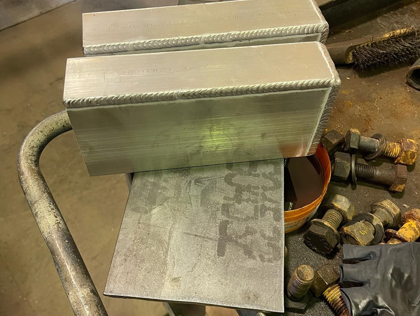 A piece of metal is sitting on top of a piece of metal on a table.