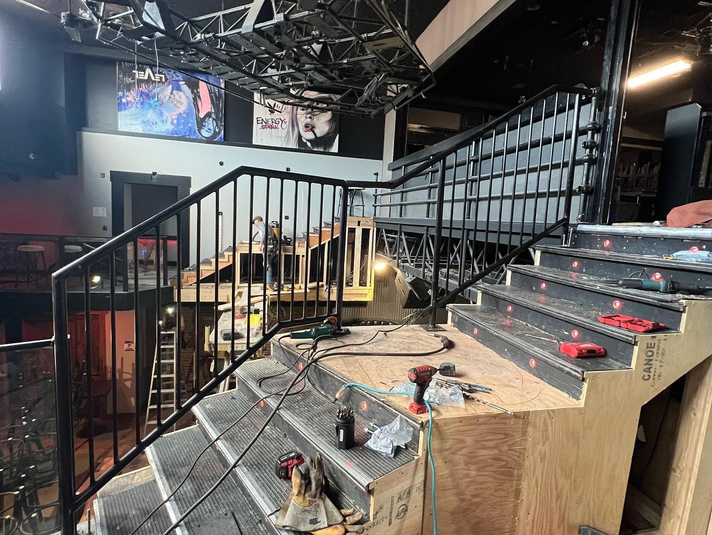 A set of stairs being built in a building with a metal railing.