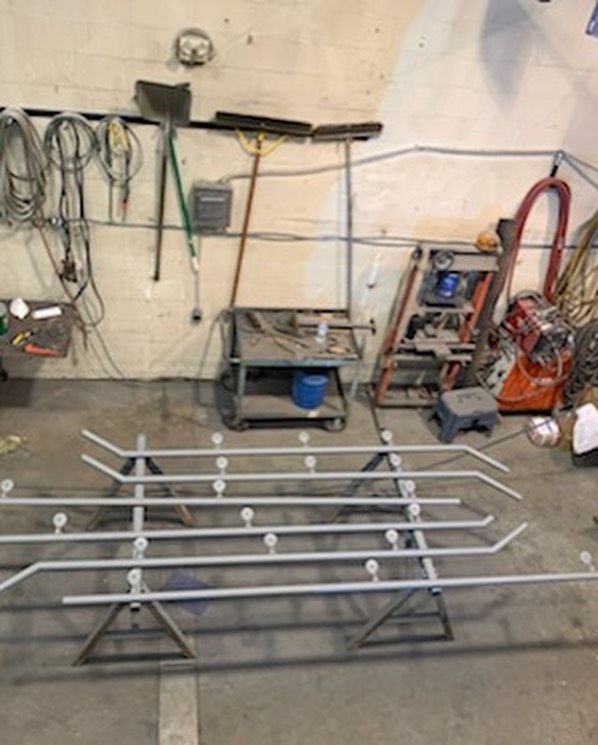 A bunch of tools are hanging on a wall in a garage