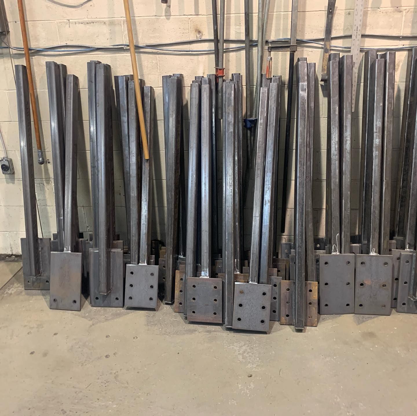 A bunch of metal poles are lined up in a row