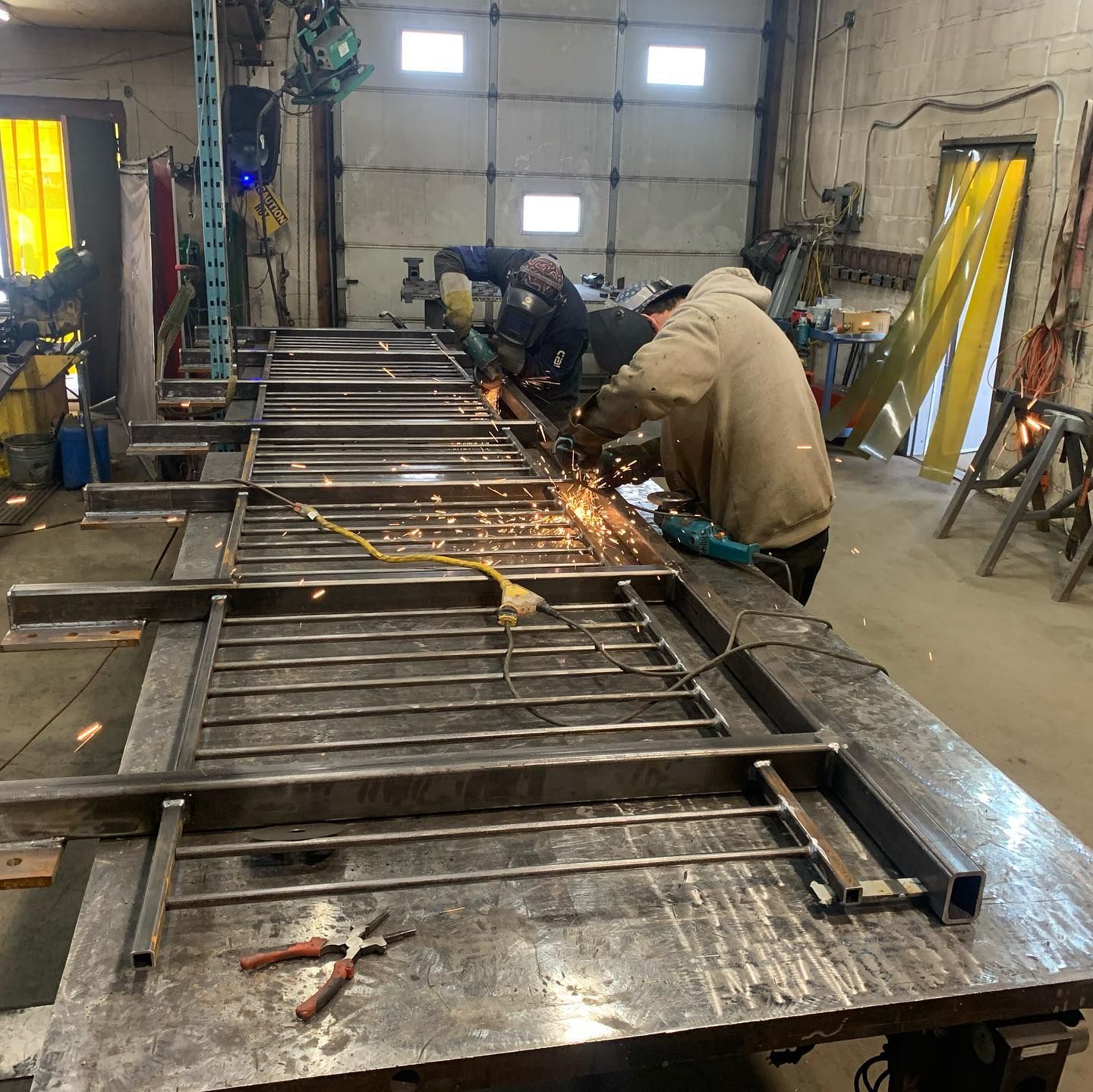 A group of men are working on a large piece of metal