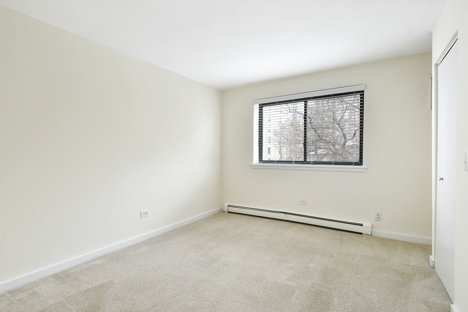 Empty bedroom with carpeted floor at Reside on Stratford.