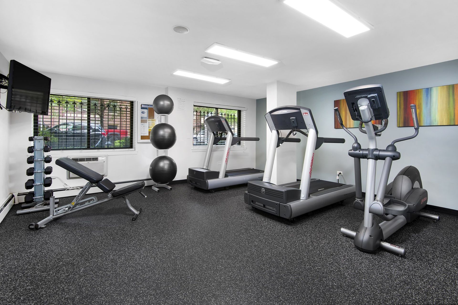 a gym with treadmills and other exercise equipment in a building