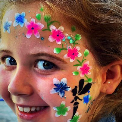 a little girl with flowers painted on her face