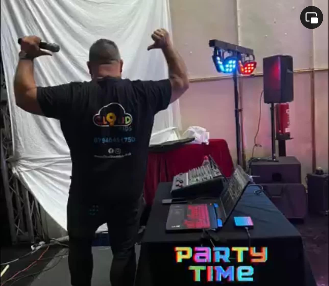a man is standing in front of a table that says party time