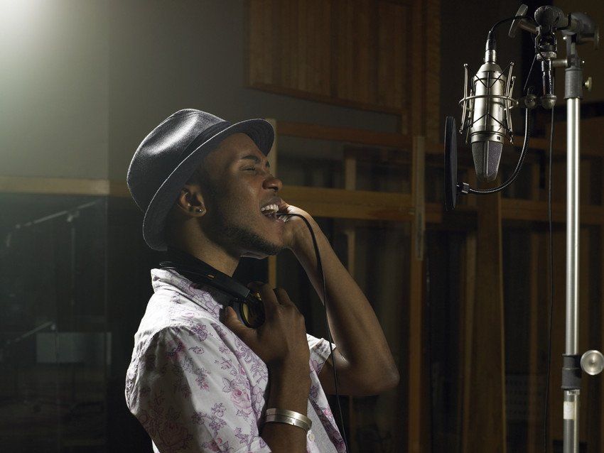 singer with hat and headphones